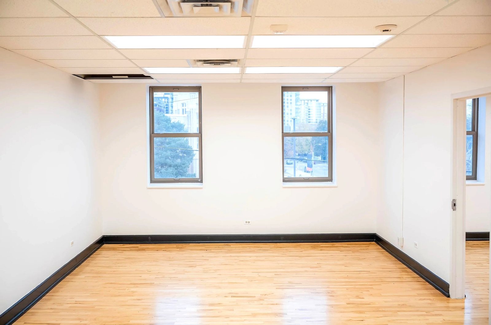 Upper level office with windows and maple floors