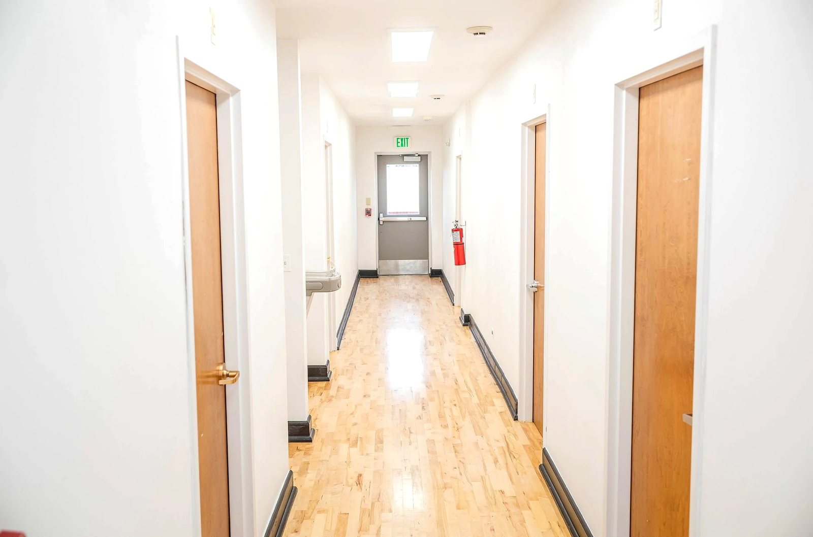 Upper level central hallway with office doors